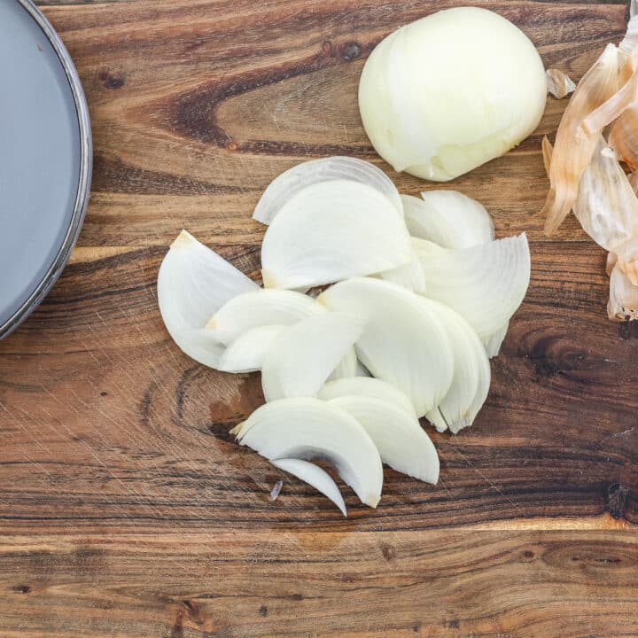 Sliced onions on a cutting board.