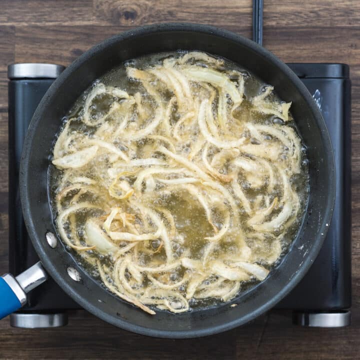 Slightly golden color French onions in oil.