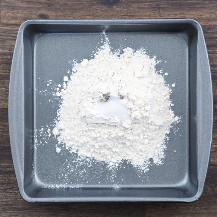 A tray with flour and basic seasonings.