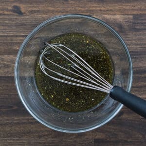 A bowl with Steak Marinade with a whisker.