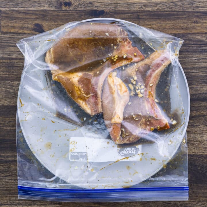 A ziplock bag with Pork chops marinated in a marinade.
