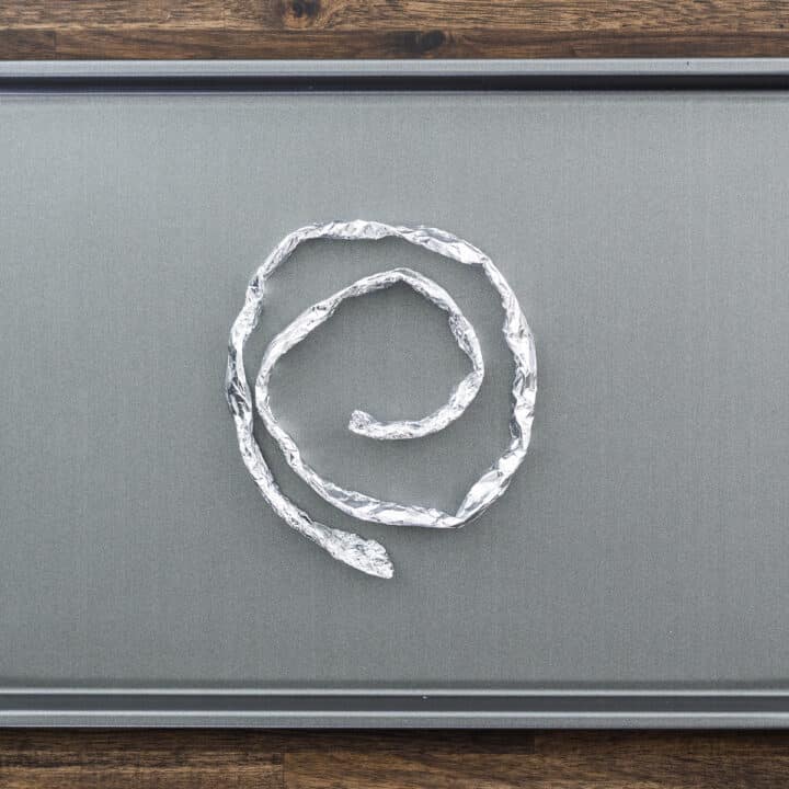 A baking tray with aluminum foil coil.