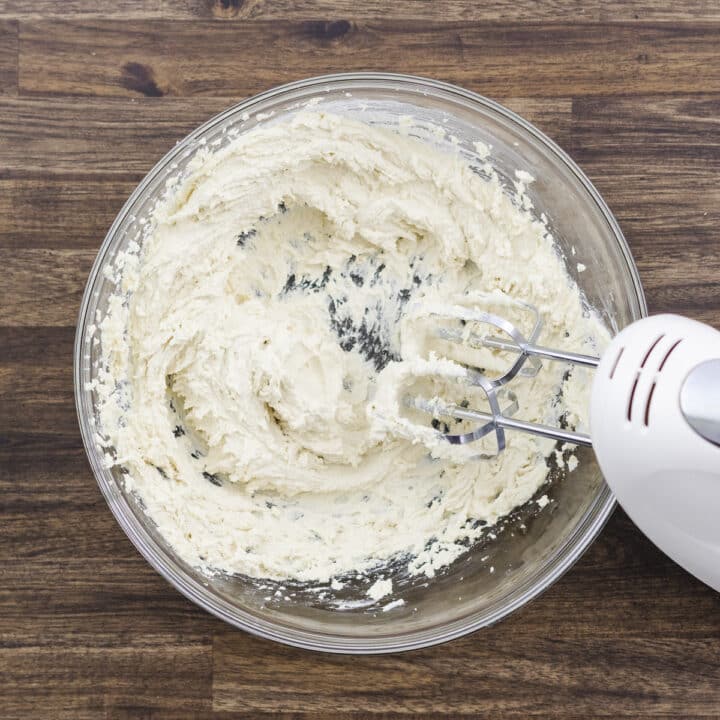 A bowl showcasing a whipped butter mixture created with an electric beater.