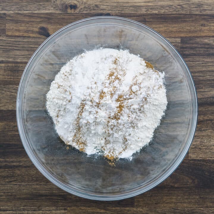 A bowl with flour, leavening agents, and pumpkin pie spice.
