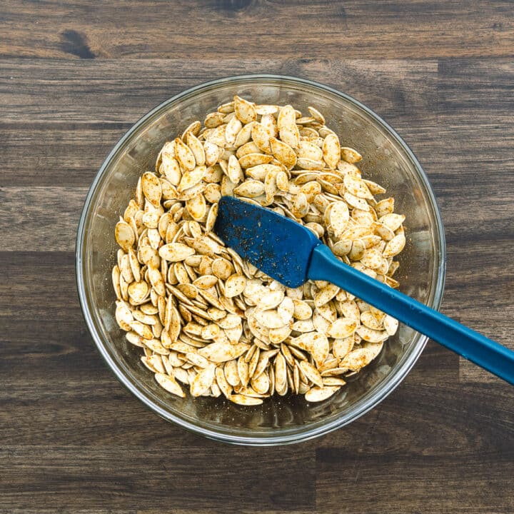 A bowl with seasoned pumpkin seeds.