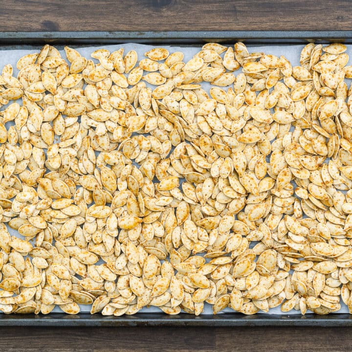 Seasoned Pumpkin seeds on a baking tray.