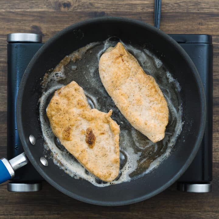 Pan with golden fried chicken breast.