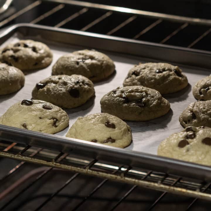 Chocolate chip cookie dough baking inside the oven.