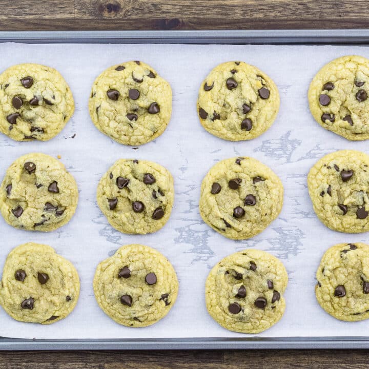 A baking tray with soft and chewy chocolate chip cookie dough.