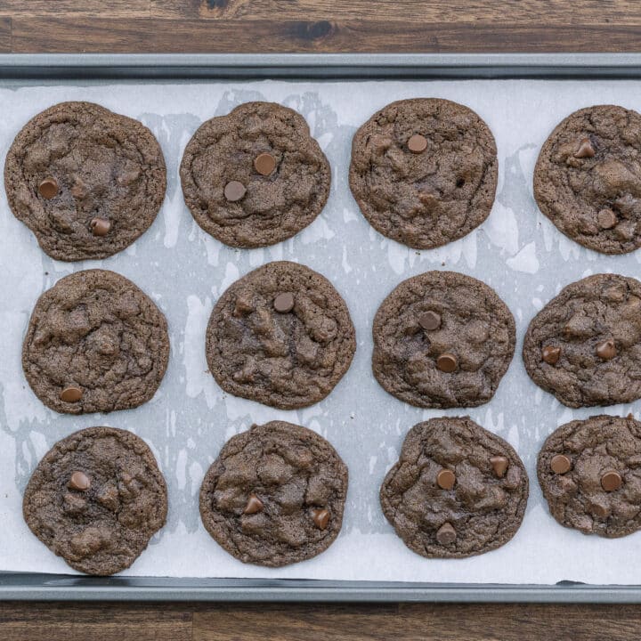 The baked double chocolate chip cookies on a tray.