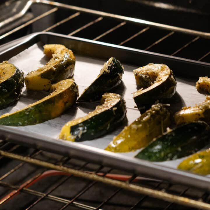Acorn squash gracefully baking inside the oven, capturing the essence of transformation.