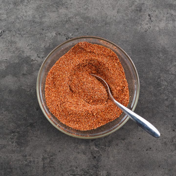 A bowl with prepared BBQ Spice Rub with a spoon.