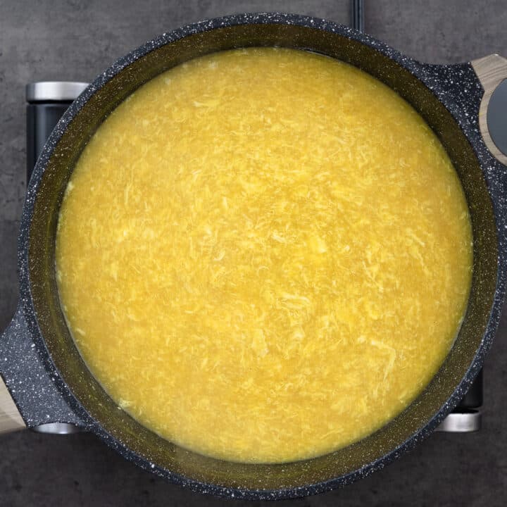 A pan filled with the process of crafting Egg Drop Soup, capturing the essence of its creation.