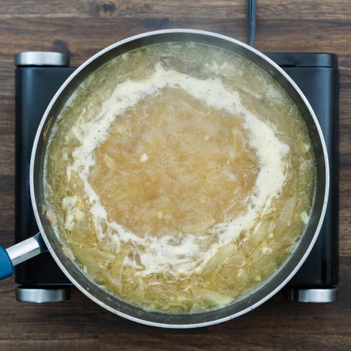 Boiling French Onion Soup in a pan.