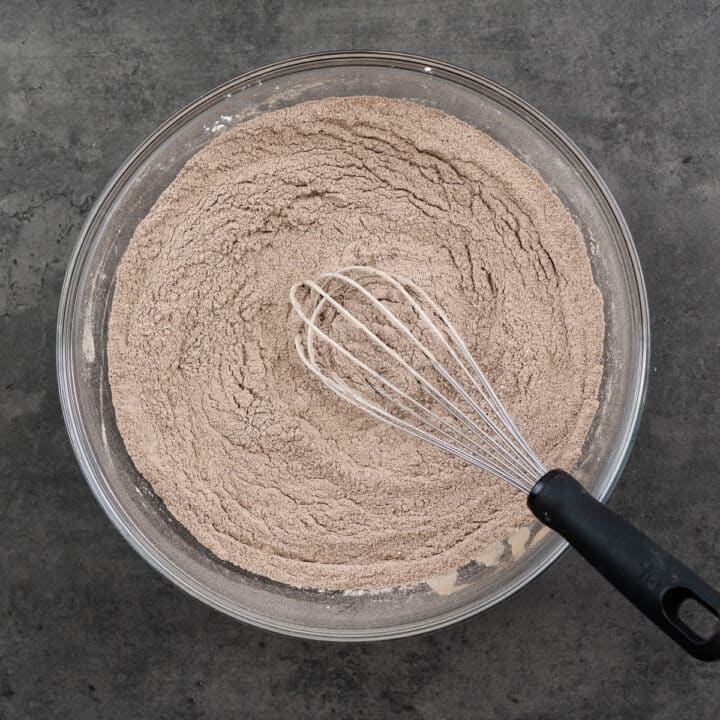 A bowl with a well-combined cocoa mix using a whisk.