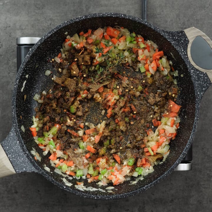 A pan with seasoned veggies, elevating the flavor profile with a perfect blend of aromatic spices.
