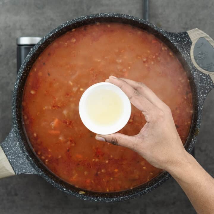 A pan ready for the addition of lemon juice to the lentil soup mixture, providing a zesty kick.