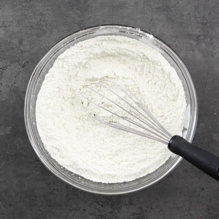 Bowl with a whisk-mixed combination of dry ingredients like all-purpose flour and leavening agents.