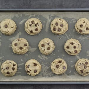 Baked peanut butter chocolate chip cookies allowed to rest in the baking tray.