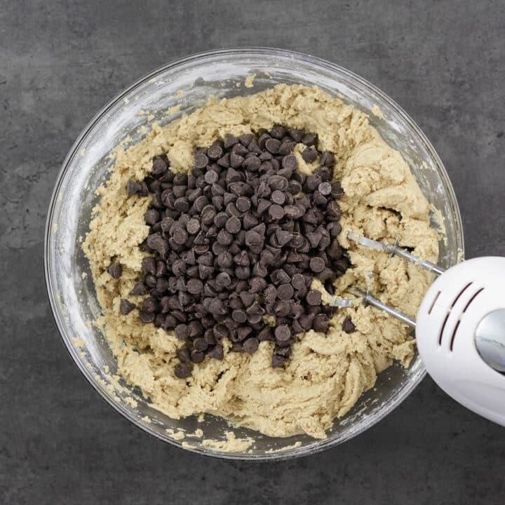 Bowl containing peanut butter cookie dough with chocolate chips.