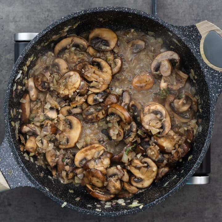 Pan with mushrooms cooking in Marsala wine.