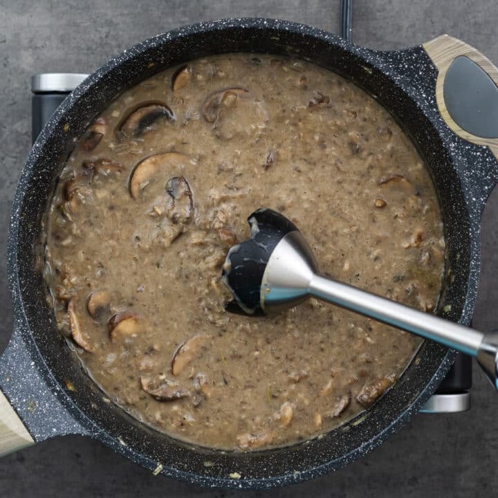 Pan with blended mushroom soup using an immersion blender.