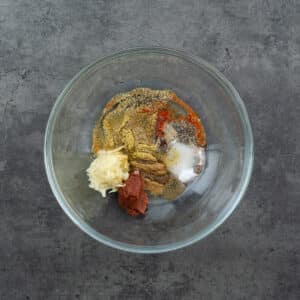 A bowl with chicken taco marinade ingredients.