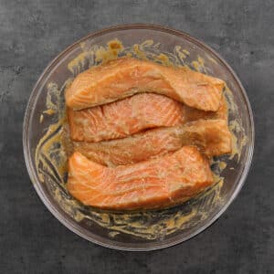Bowl with salmon immersed in miso glaze marinade.