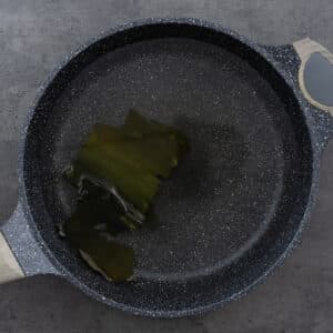 Kombu soaking in water in a pot.
