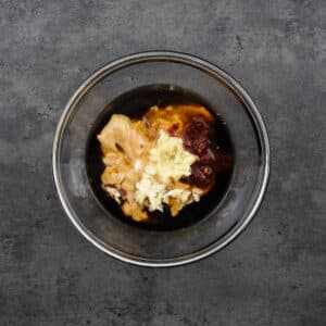 Bowl with ingredients for peanut sauce.