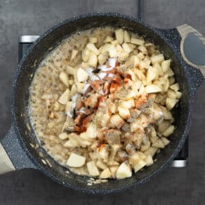Potatoes seasoned with basic spices in a pan.