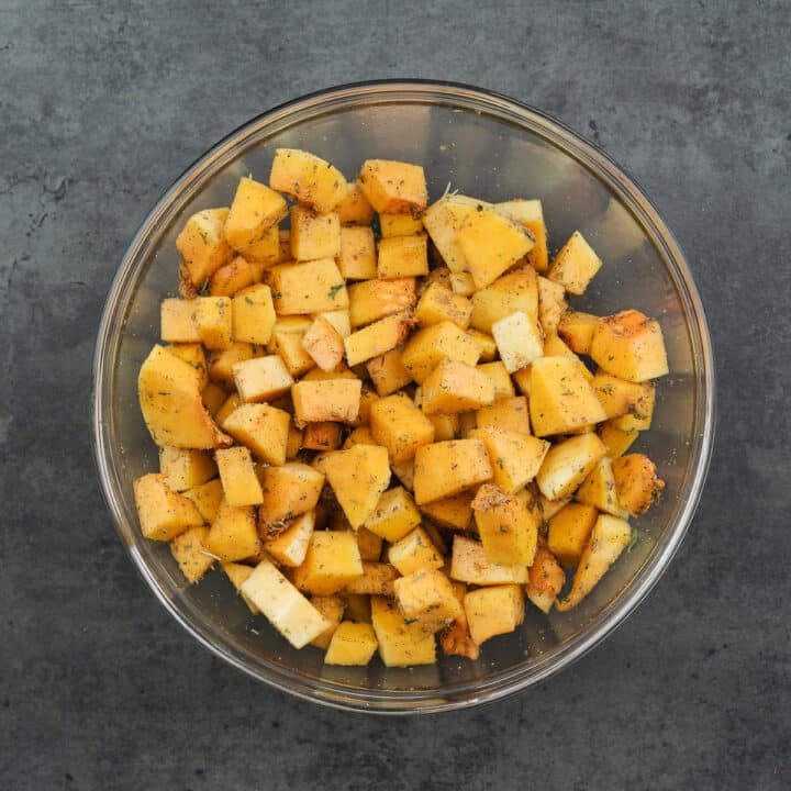 A bowl with seasoned butternut squash.