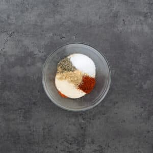 A bowl filled with salmon seasoning ingredients.