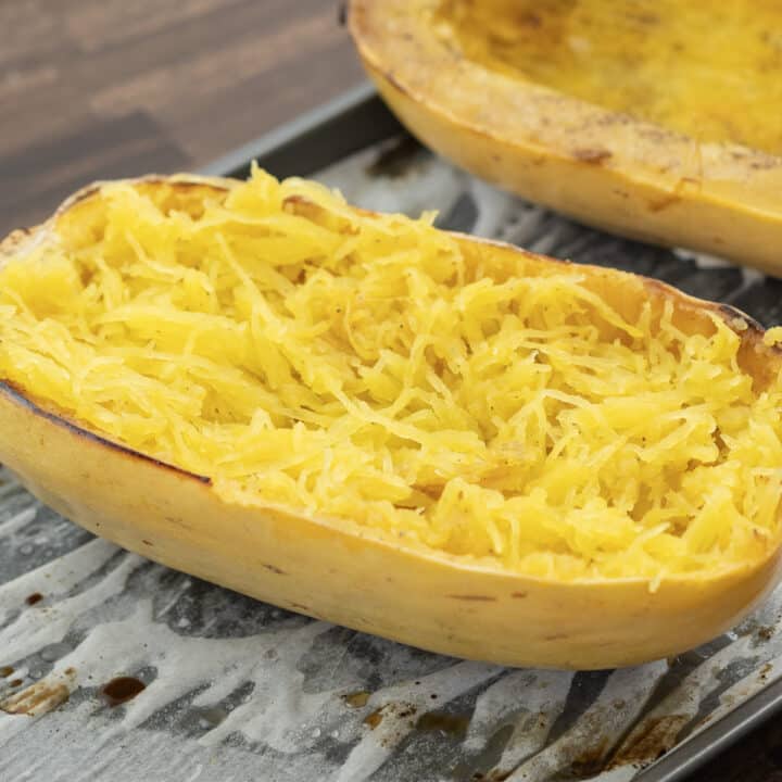 Golden cooked spaghetti squash served in a tray.