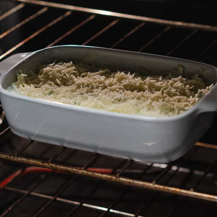 Spinach artichoke dip baking inside the oven.