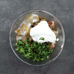 A bowl filled with chicken cubes and kabob ingredients.
