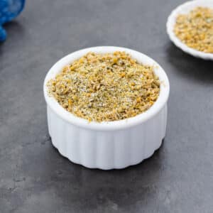Lemon pepper seasoning served in a white bowl.