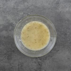 Bowl of lemon vinaigrette dressing.