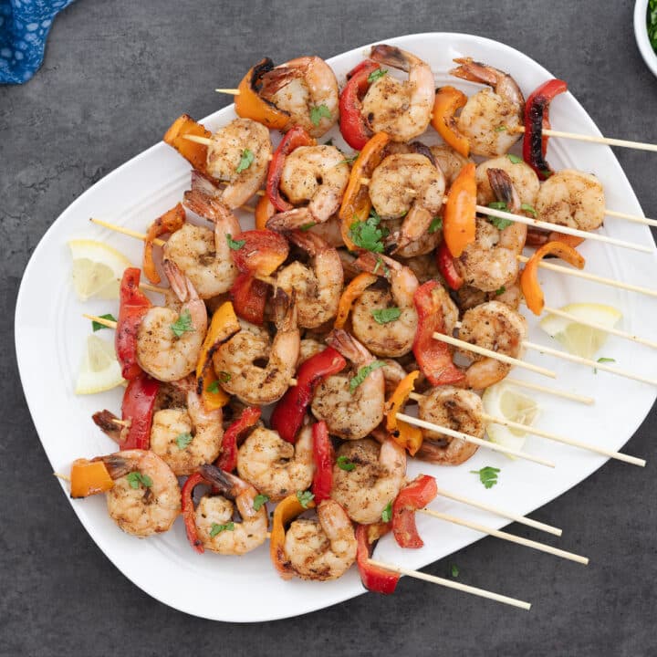 Grilled Shrimp Skewers kabobs placed in a serving tray.
