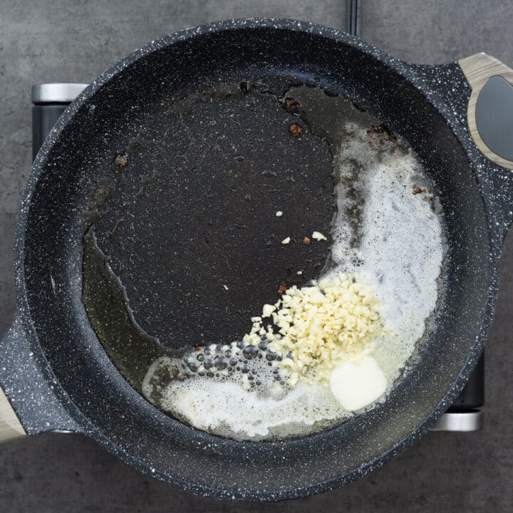 Butter and garlic in a pan, ready for sauteing.