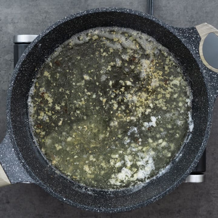 Chicken broth and lemon juice mixture boiling in a pan.