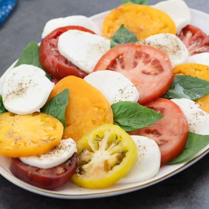 Caprese Salad elegantly served on an oval plate.