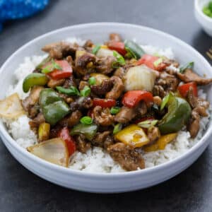 Cashew Chicken served over white rice in a bowl.