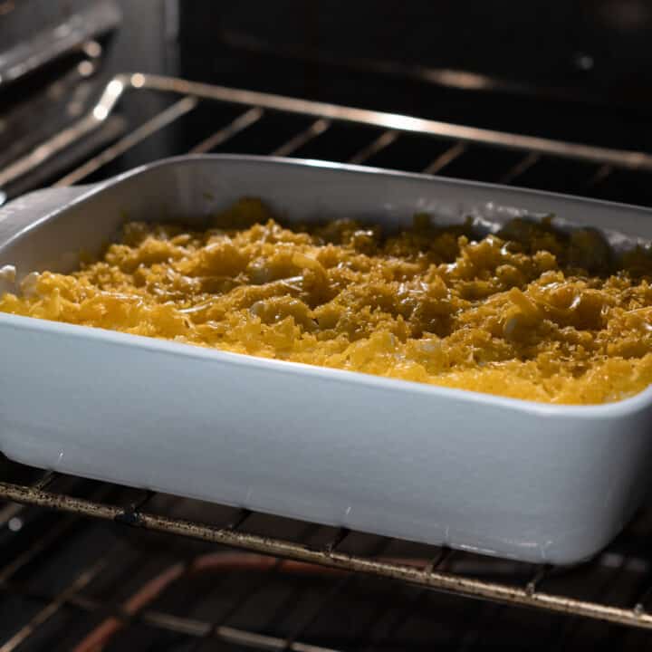 A baking dish of macaroni and cheese baking in the oven.