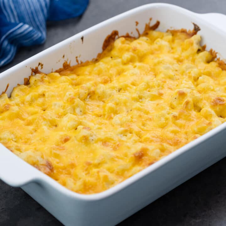 A serving of macaroni and cheese in a baking dish, ready to be enjoyed.