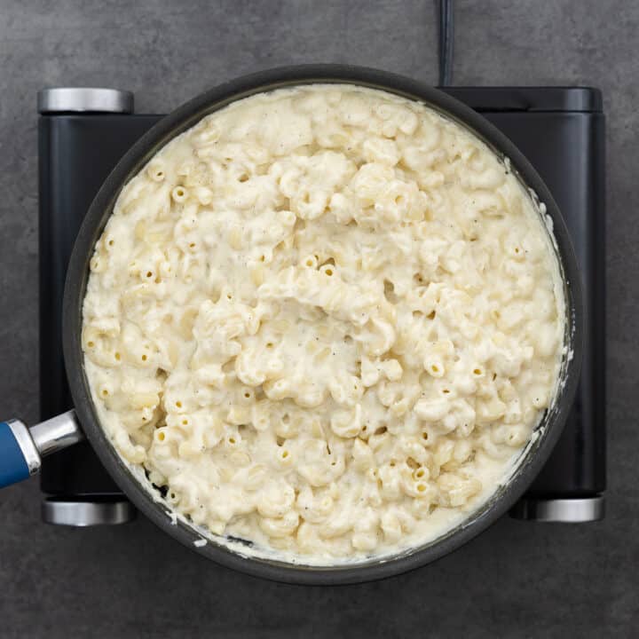 A pan of macaroni and cheese placed on the stove.