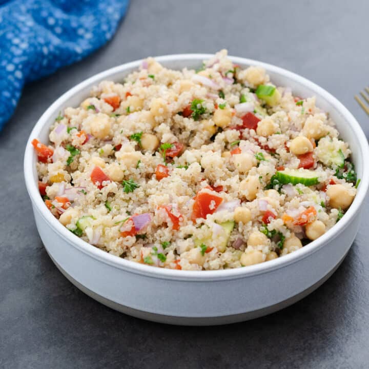 A healthy quinoa salad served in a white bowl, ready to be enjoyed.