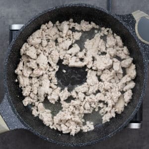 A pan with cooked ground chicken meat.