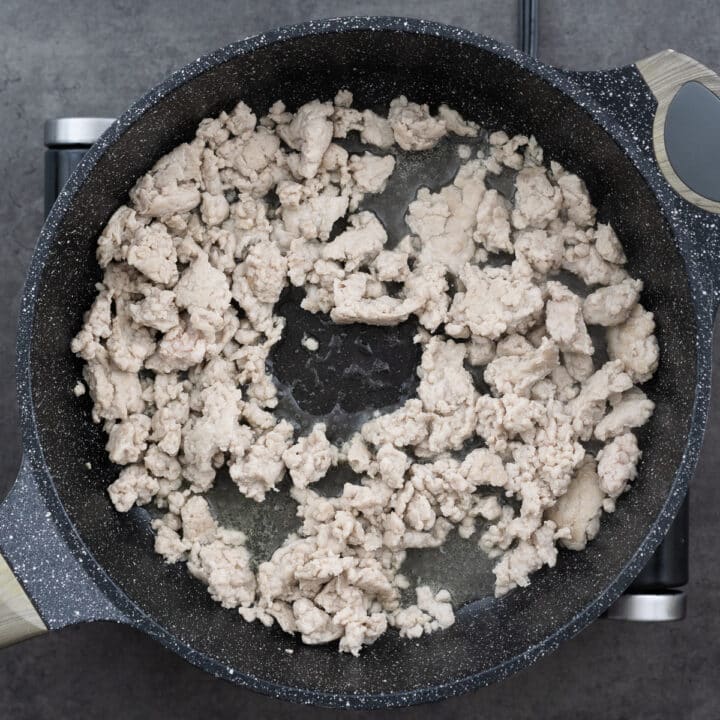 A pan with cooked ground chicken meat.