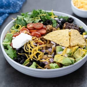 Taco salad served in a white bowl.